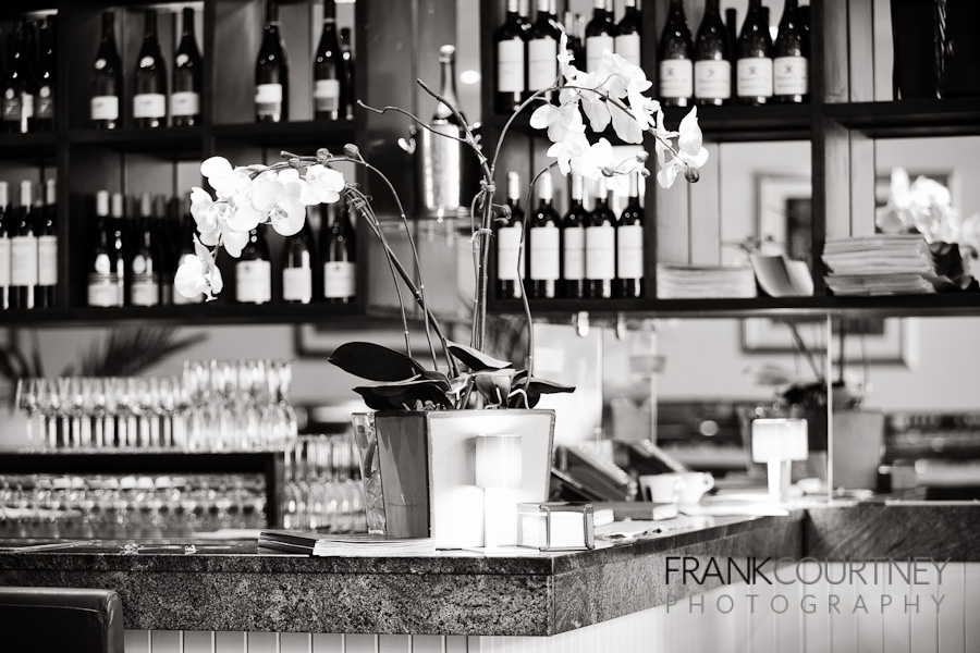 Counter with plant and wine bottles in the background.